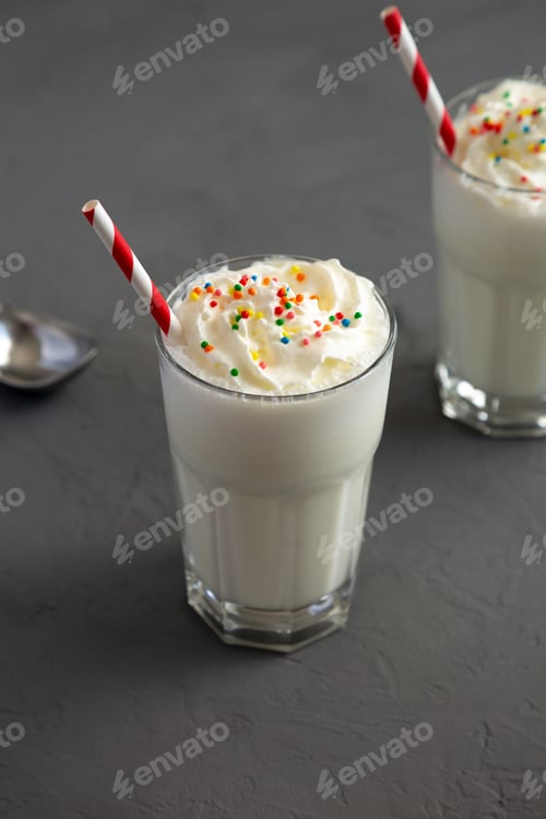 Preview: Homemade Vanilla Milk Shake with Whipped Cream, low angle view.
