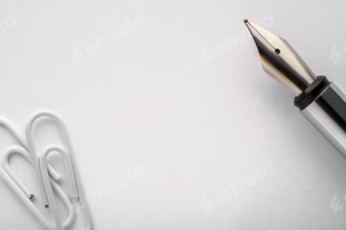 Preview: Fountain pen on a white paper with paper clips.
