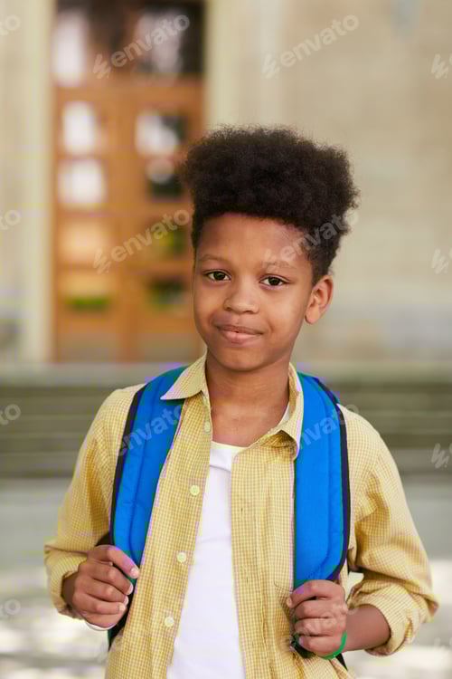 Preview: Smiling Boy Wearing Backpack Outside School Building