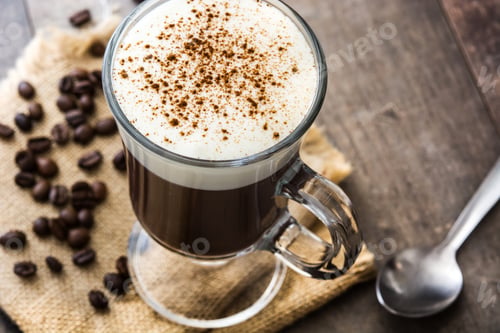 Preview: Irish coffee with whipped cream and cinnamon being served on rustic wooden table