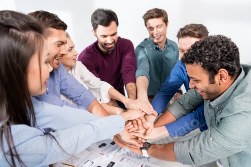 Preview: business team giving highfive together on workplace in office, young professional group concept
