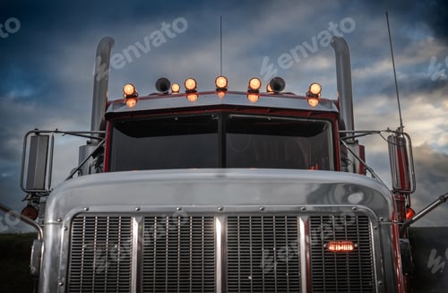 Preview: Truck With Shining Lights Against a Moody Sky During Twilight Hours