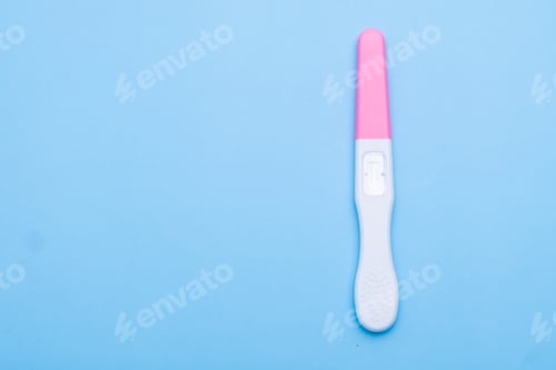 Preview: Unused pink and white pregnancy test on the blue background