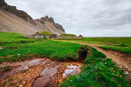 Preview: Traditional Viking village. Wooden houses near the mountain firs