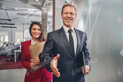 Preview: Kind senior man welcoming new business partner