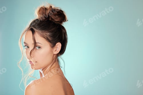 Preview: Studio portrait of an attractive young woman posing against a blue background