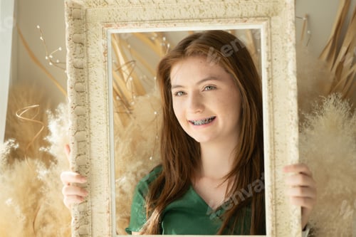 Preview: Portrait of Teenage girl with braces in picture frame