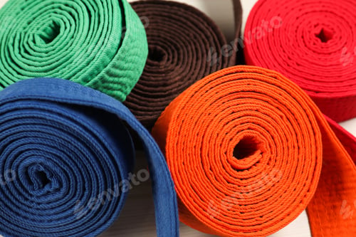 Preview: Colorful karate belts, closeup. Martial arts uniform