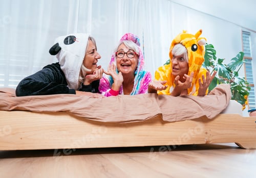 Preview: Beautiful senior women having funny pajama party at home