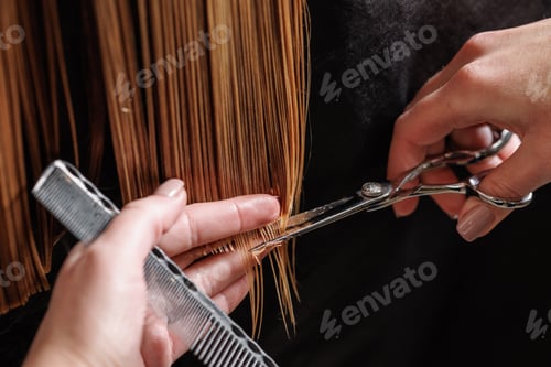 Preview: hairdresser makes a haircut to a woman in the salon