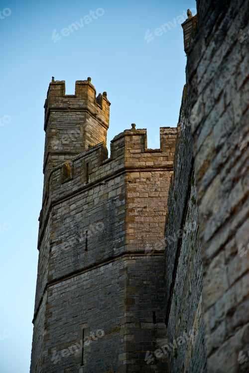 Preview: Vertical shot of the Caernarfon Castle against the blue sky in Wales