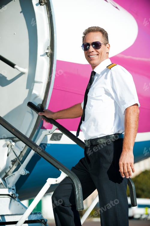 Preview: Ready to flight! Confident male pilot in uniform going into the airplane and smiling
