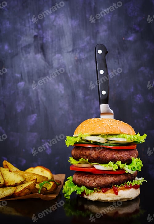 Preview: Delicious handmade burger on dark background. Close view