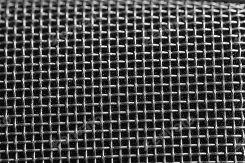 Preview: Metal mesh of microphone as background, closeup. Musical equipment