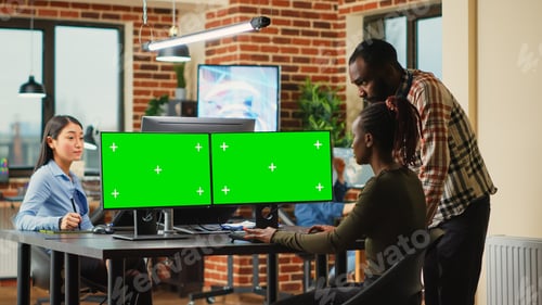 Preview: African american workers using greenscreen display on monitors