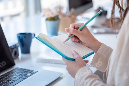 Preview: Woman colleg student who taking note online learning at home.