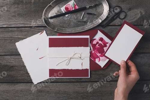 Preview: top view of woman preparing holiday invitations
