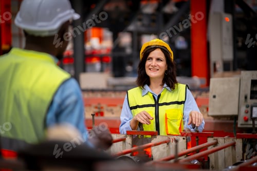 Preview: Young female engineer in metal sheet factory Responsible work is being inspected at actual work site