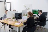 Preview: Four colleagues working in a modern office with computers