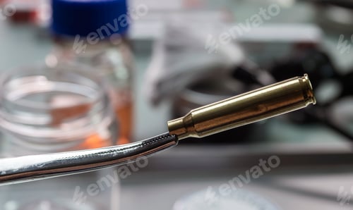 Preview: Criminalistic Laboratory, Scientific police officer holds bullet tips with tweezers
