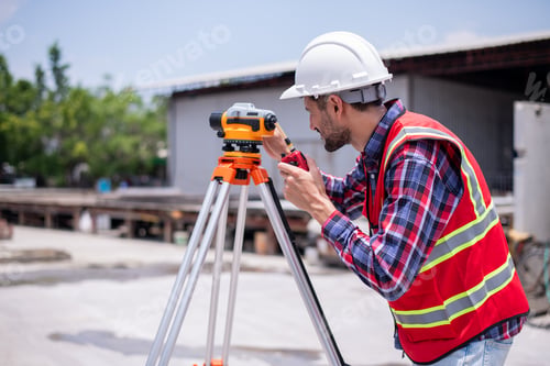 Preview: Construction surveyors wearing safety helmets and reflective working using theodolite