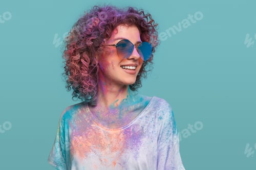 Preview: Woman in glasses and Holi powder in studio