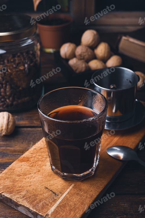 Preview: Glass of coffee brewed in traditional vietnamese drip filter