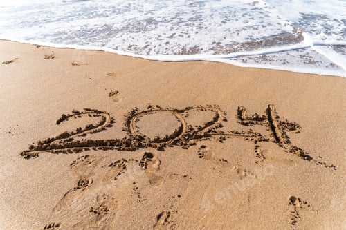 Preview: 2024 hand written in sand on a beautiful beach