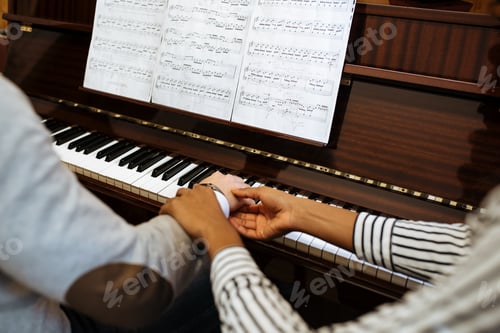 Preview: Man playing piano near woman teaching in studio
