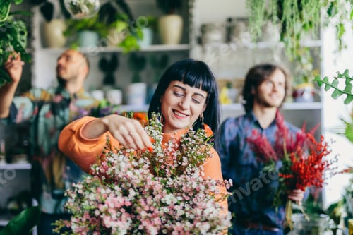 Preview: Woman working with florists in flower store