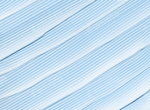 Preview: cosmetic smear cream texture on pastel background