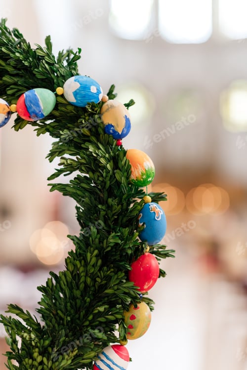 Preview: Green Christmas wreath with decorations on bright background.easter eggs