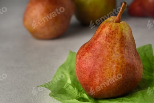Preview: Red ripe pears on a light background. Copy space. Selective focus.