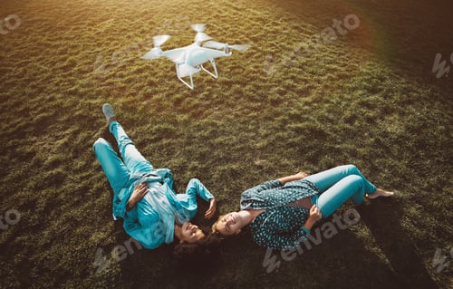 Preview: Two girls of different races on the grass and drone