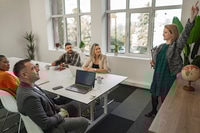 Preview: Engaged Female Presenter Addressing Colleagues During a Bright D