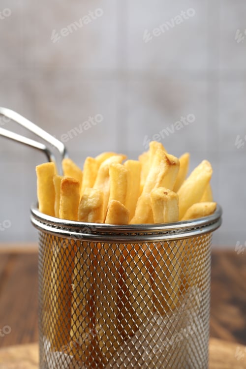Preview: Tasty french fried served on wooden table, closeup