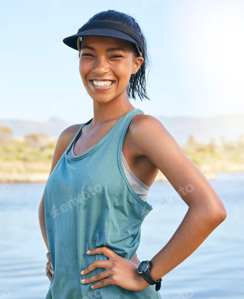 Preview: Portrait mixed race woman standing with her hands on her hips outside. Latin woman out on the lake