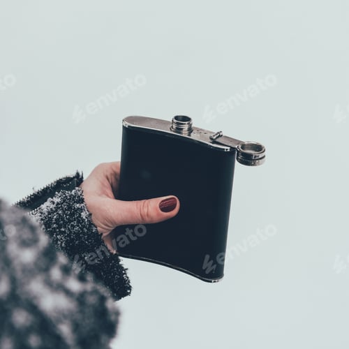 Preview: cropped shot of woman holding flask in hand on winter day
