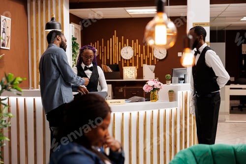 Preview: Receptionist and guest at front desk