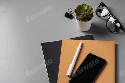 Preview: Office desk with notepad, glasses and supplies