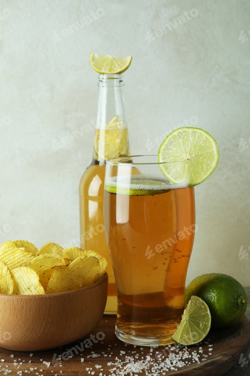 Preview: Beer with snacks against white textured background
