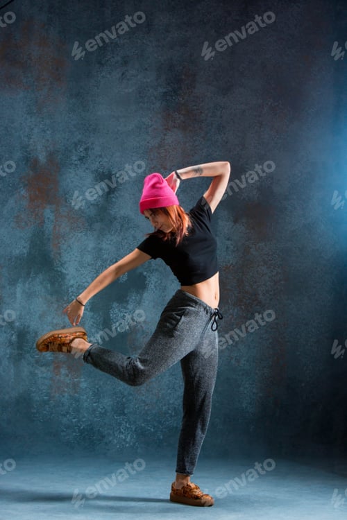 Preview: Young girl break dancing on wall background.