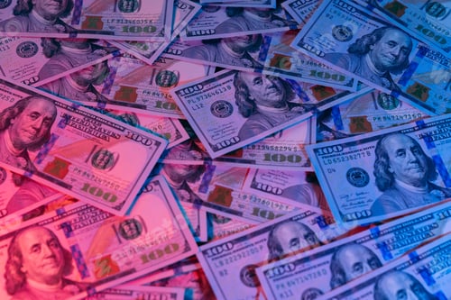 Preview: Money background enlighten by red and blue light