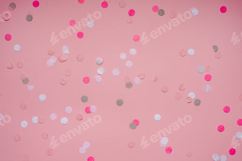 Preview: Party colorful confetti over pink background . Top view, flat lay