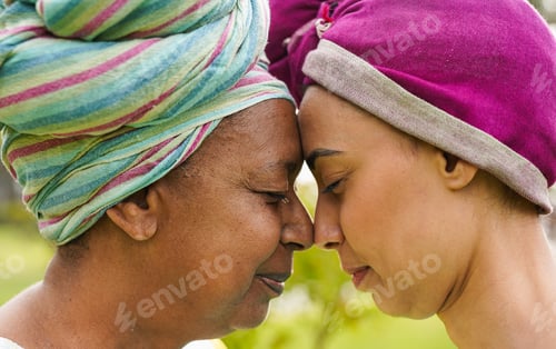 Preview: African mother and daughter having tender moment together outdoor