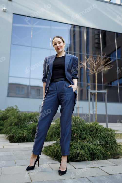 Preview: Business woman in elegance blue formal suit posing outdoors
