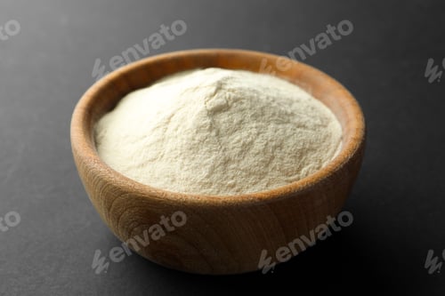 Preview: Bowl of agar-agar powder on black background, closeup