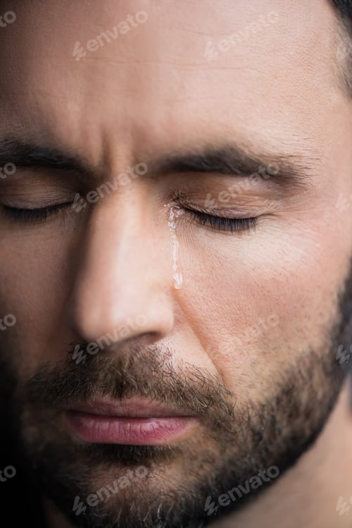 Preview: portrait of handsome depressed man crying with closed eyes