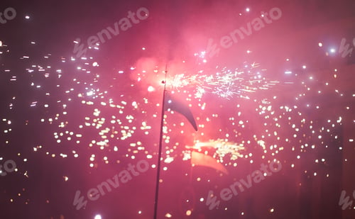 Preview: silhouette of a scythe and fireworks in the background. selective focus out-of-focus background