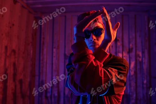 Preview: Man Posing amidst Neon Lights and Wooden Walls